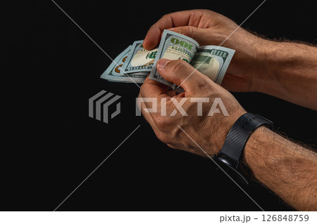 Counting cash with a focus on hundred dollar bills at night 126848759