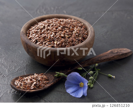 Flax seed and flax blue flower on concrete backgrounds 126851210