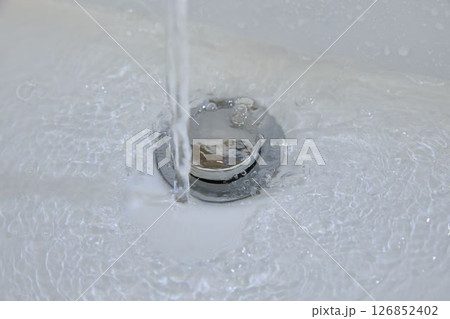 Clear Water Swirls Into The Bathroom Drain 126852402