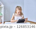 Young Girl Engaged with Tablet Technology. Copy space 126853146