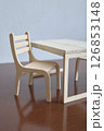 Minimalist Wooden Chair and Table Set on Wooden Surface 126853148