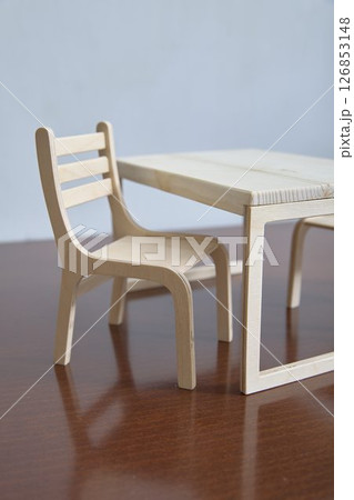 Minimalist Wooden Chair and Table Set on Wooden Surface Minimalist Wooden Chair and Table Set on Wooden Surface 126853148