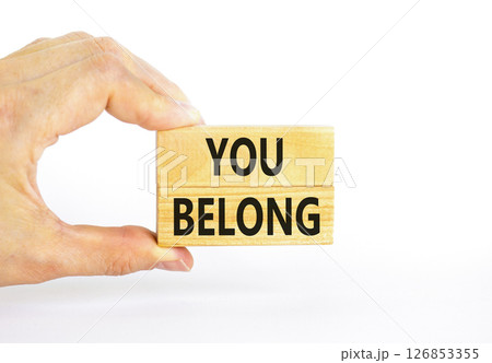 Belonging and you belong symbol. Concept words You belong on beautiful wooden blocks. Beautiful white background. Businessman hand. Business belonging and you belong concept. Copy space. 126853355
