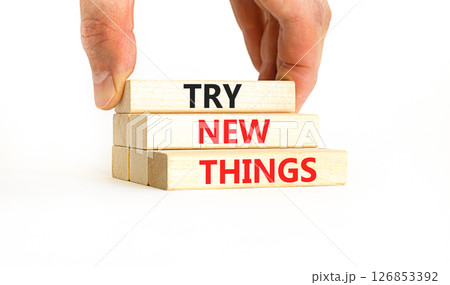 Try new things symbol. Concept words Try new things on beautiful wooden block. Businessman's hand. Beautiful white background. Business motivational lifestyle try new things concept. Copy space. Try new things symbol. Concept words Try new things on beautiful wooden block. Businessman's hand. Beautiful white background. Business motivational lifestyle try new things concept. Copy space. 126853392