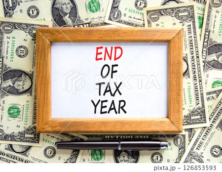 End of tax year symbol. Concept words phrase End of tax year on beautiful wooden picture frame. Dollar bills. Beautiful dollar bills background. Business End of tax year concept. Copy space. 126853593