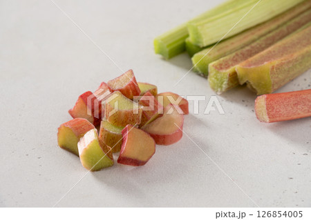Freshly chopped green rhubarb on white background. Trendy organic food. Ready for cooking. Vegan concept. Close up. Freshly chopped green rhubarb on white background. Trendy organic food. Ready for cooking. Vegan concept. Close up. 126854005