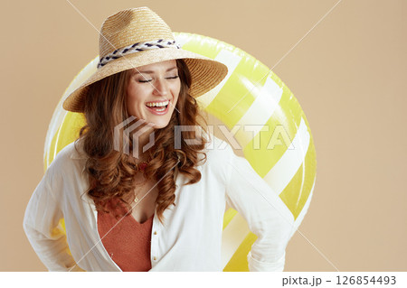 happy elegant housewife in blouse and shorts against beige 126854493