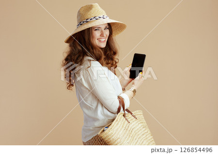 happy trendy woman showing smartphone blank screen 126854496