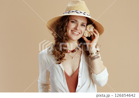 smiling stylish woman in blouse and shorts isolated on beige smiling stylish woman in blouse and shorts isolated on beige 126854642