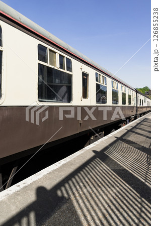 Perspective view of Brown and cream railway carriages at Tunbridge Wells railway station. 126855238
