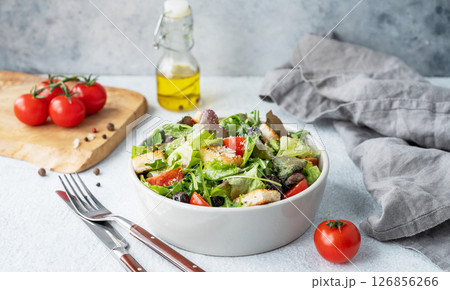 Vegetarian salad with lettuce, tomatoes, croutons, olives and parmesan cheese  in a bowl 126856266