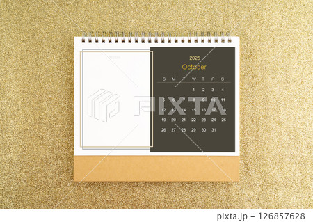 Desk calendar for October 2025 on gold glitter background. Desk calendar for October 2025 on gold glitter background. 126857628