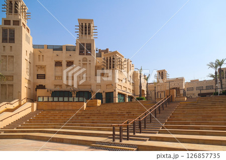 Majestic Arabic-Style Architecture: Grand Light-Stone Buildings Against a Clear Blue Sky 126857735