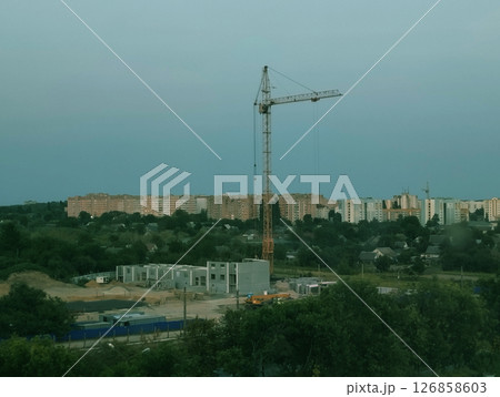 Construction in the city. Infill development in the city. Construction crane for the construction of a residential building 126858603
