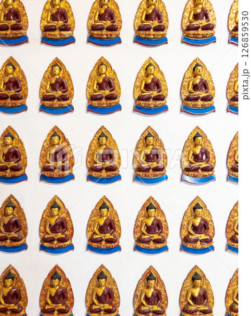Intricate Buddha Statues on Temple Wall. 126859530
