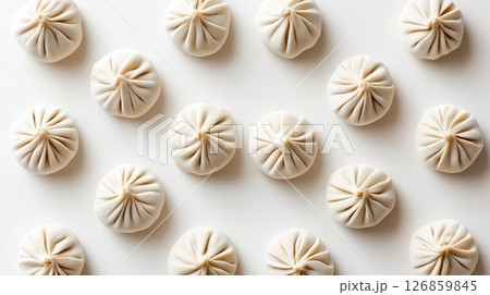 Top Down View of Raw Dumplings Evenly Arranged on White Background 126859845