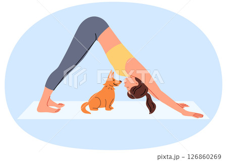 Woman does pilates on yoga mats and does stretching located near with funny puppy 126860269