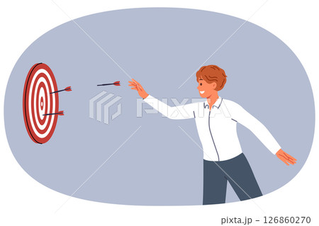 Business man is trying to hit target and achieve desired result by throwing darts at dartboard 126860270