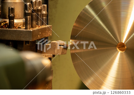 Close up scene the lathe machine finish cut the brass material parts by chip insert tool. Close up scene the lathe machine finish cut the brass material parts by chip insert tool. 126860333