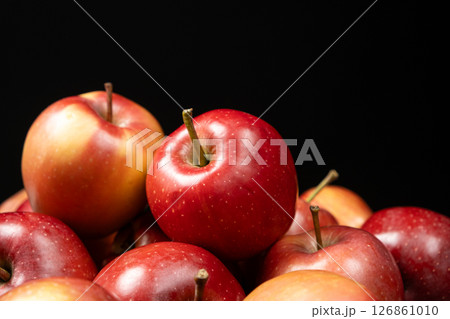 Group of fresh organic red whole apples on a black background 126861010