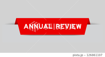 Red color inserted label with word annual review on gray background Red color inserted label with word annual review on gray background 126861107