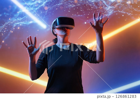 Woman with VR virtual reality goggles 126861283