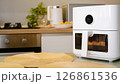 White air fryer cooking food in modern kitchen 126861536