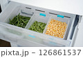 Frozen vegetables preserving freshness in refrigerator drawer: peas, green beans, and corn 126861537