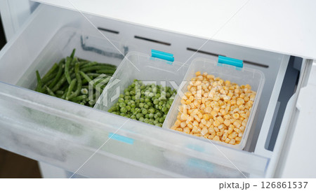 Frozen vegetables preserving freshness in refrigerator drawer: peas, green beans, and corn 126861537