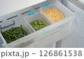 Frozen vegetables preserving freshness in refrigerator drawer: peas, corn, and green beans 126861538