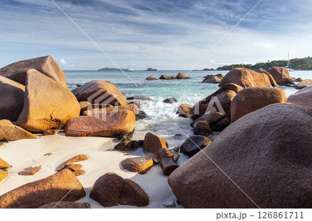 A beautiful coastal landscape showcasing large boulders by the sea A beautiful coastal landscape showcasing large boulders by the sea 126861711