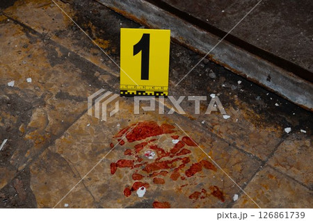Bloody Boot Print on Floor with Evidence Marker at Crime Scene Bloody Boot Print on Floor with Evidence Marker at Crime Scene 126861739