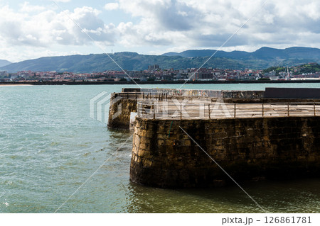 A historic stone pier stretches into the bay, capturing the essence of Getxo, Basque country A historic stone pier stretches into the bay, capturing the essence of Getxo, Basque country 126861781