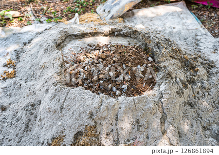 Manual concrete mixing with sand, cement and water, using shovel and trowel on outdoors Manual concrete mixing with sand, cement and water, using shovel and trowel on outdoors 126861894