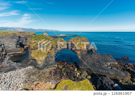 Coastal view of Gatklettur Rock Arch with basalt cliff in summer at Arnarstapi, Iceland Coastal view of Gatklettur Rock Arch with basalt cliff in summer at Arnarstapi, Iceland 126861907