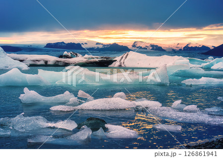 Sunset over blue iceberg floating during summer in Jokulsarlon glacier lagoon at Iceland 126861941