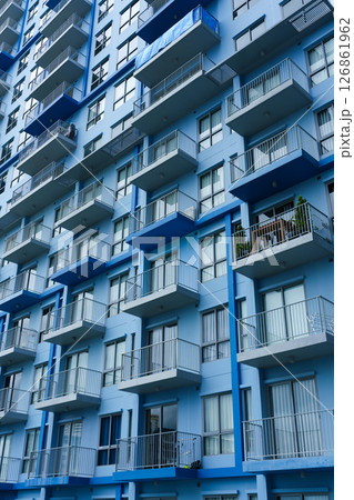 Blue facade modern condominium with balcony and glass windows Blue facade modern condominium with balcony and glass windows 126861962