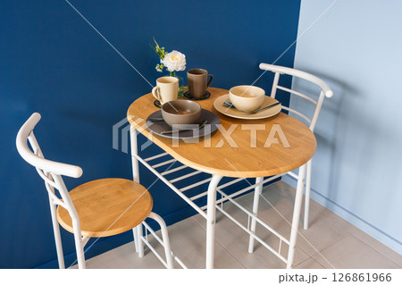 Modern Minimalist Dining Setup with Table and Ceramic Dishware Modern Minimalist Dining Setup with Table and Ceramic Dishware 126861966