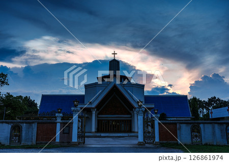 Mysterious cloud iridescence glowing over christian church in the evening Mysterious cloud iridescence glowing over christian church in the evening 126861974