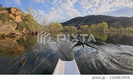 rowing scenery from a calm lake at foothills of Rocky Mountains - rower POV view rowing scenery from a calm lake at foothills of Rocky Mountains - rower POV view 126862050