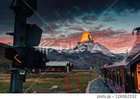 Golden sunrise over Matterhorn mountain during train riding up to Gornergrat station at Zermatt 126862102