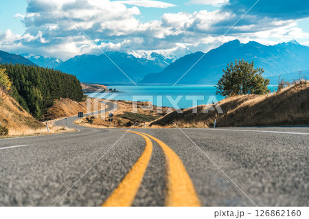 Winding road leading to Mount Cook and Lake Pukaki on sunny day at Peters lookout, New Zealand Winding road leading to Mount Cook and Lake Pukaki on sunny day at Peters lookout, New Zealand 126862160