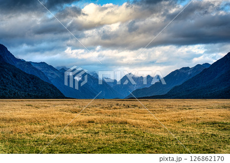 Scenery of Eglinton Valley with mountain range and meadow from Milford Road in autumn Scenery of Eglinton Valley with mountain range and meadow from Milford Road in autumn 126862170
