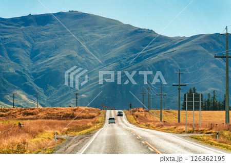 Road trip with car driving on the road during autumn and mountain background at New Zealand Road trip with car driving on the road during autumn and mountain background at New Zealand 126862195