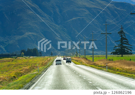 Road trip with car driving on the road during autumn and mountain background at New Zealand Road trip with car driving on the road during autumn and mountain background at New Zealand 126862196
