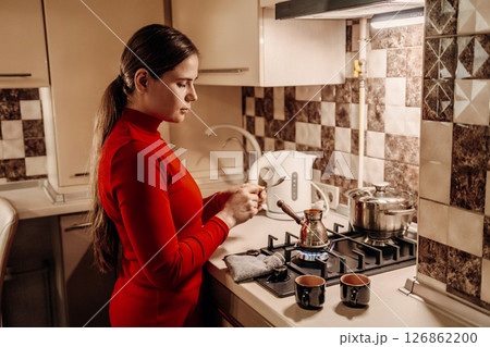 Woman Kitchen Coffee: Evening preparation of Turkish coffee at home. Woman Kitchen Coffee: Evening preparation of Turkish coffee at home. 126862200