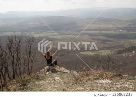 Woman Mountain View, Girl celebrates atop mountain peak, appreciating nature on sunny day, raising arms 126862238