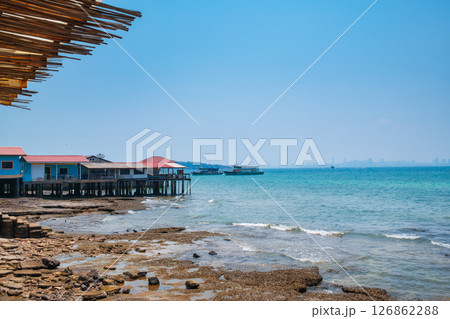 Fishing village built on tropical sea and ferry boat by the dock in summer at Koh Larn island Fishing village built on tropical sea and ferry boat by the dock in summer at Koh Larn island 126862288