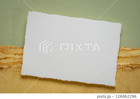 small blank sheet of watercolor paper on a  tan toned paper 126862296