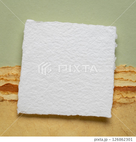 small blank sheet of watercolor paper on a tan toned paper small blank sheet of watercolor paper on a tan toned paper 126862301